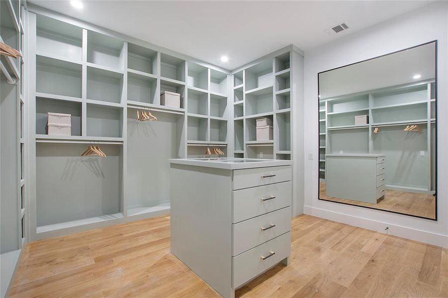 Spacious closet with light hardwood / wood-style floors