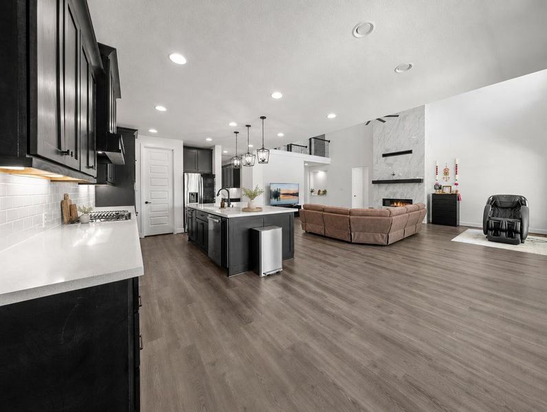 An open-concept living area offers an inviting flow between the kitchen and spacious great room, highlighted by high ceilings. An open-concept living area offers an inviting flow between the kitchen and spacious great room, highlighted by high ceilings.