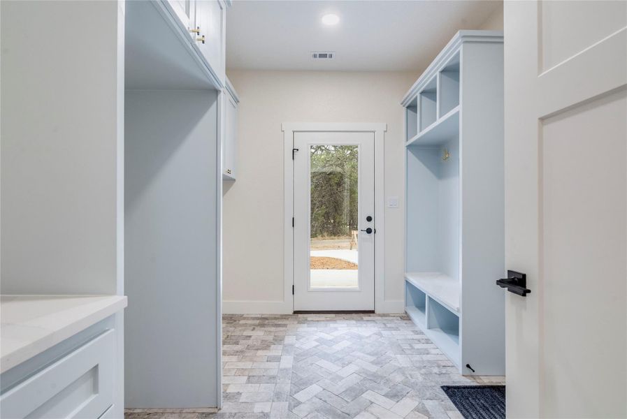 Mudroom featuring baseboards and recessed lighting
