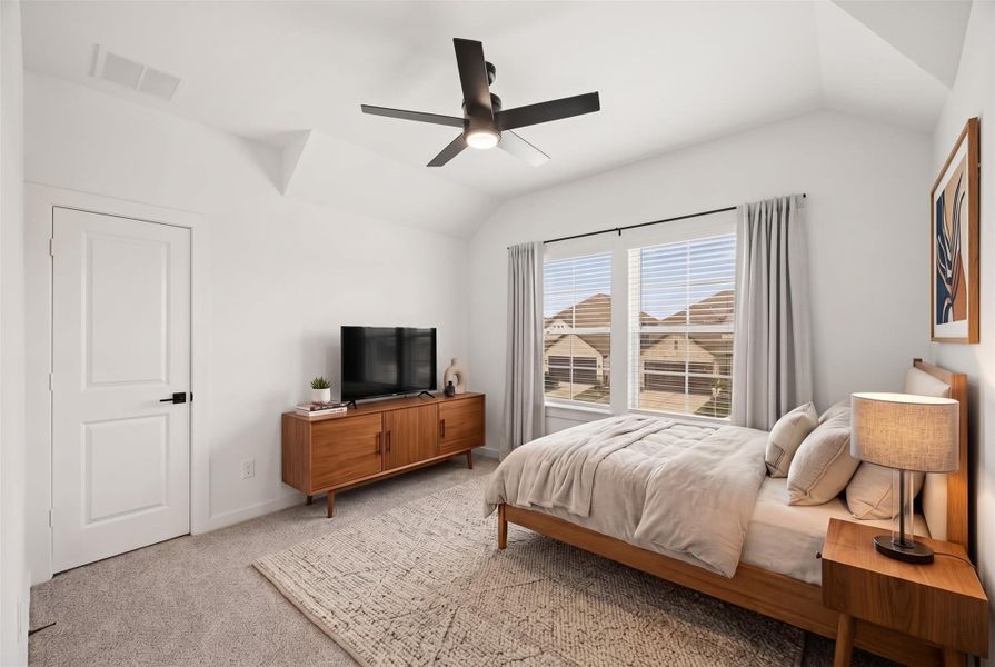 Located just off the game room, this secondary bedroom offers plush carpet, two windows with blinds for natural light, privacy and an elegant tray ceiling that adds architectural interest. This photo has been virtually staged. Located just off the game room, this secondary bedroom offers plush carpet, two windows with blinds for natural light, privacy and an elegant tray ceiling that adds architectural interest. This photo has been virtually staged.