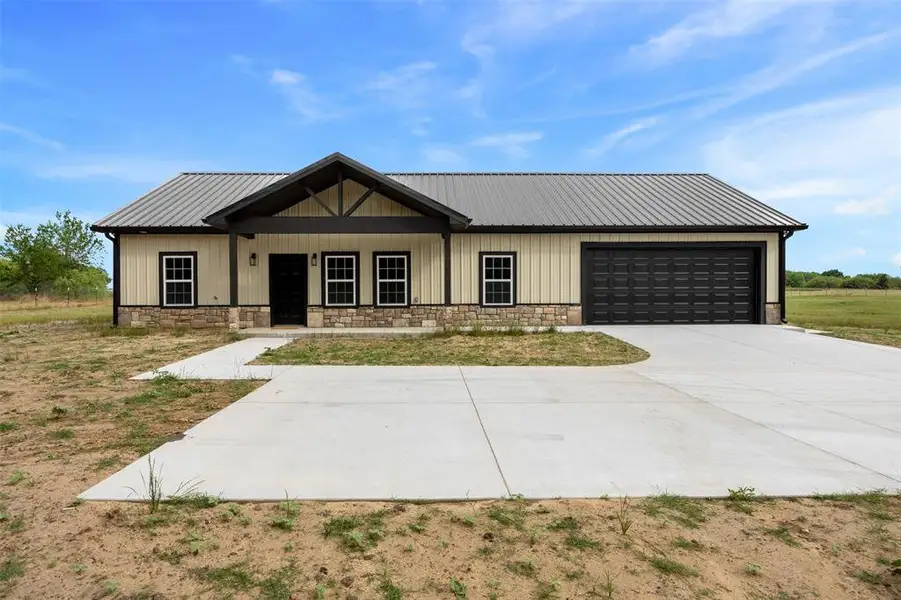 Front exterior of a new home in , Ennis, TX, highlighting curb appeal (Image 18).