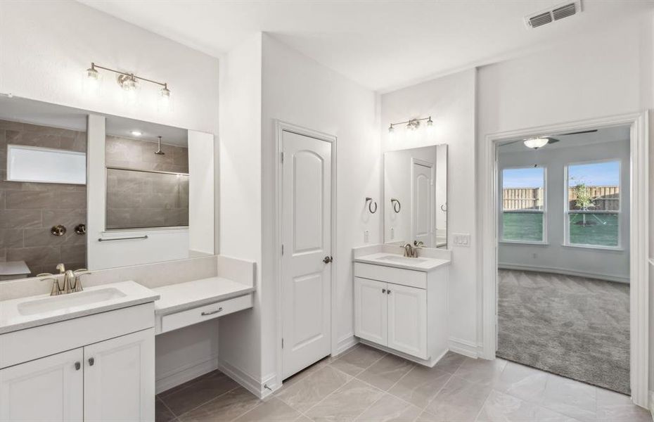 Spacious owner's bathroom with dual vanity and oversized shower*real home pictured