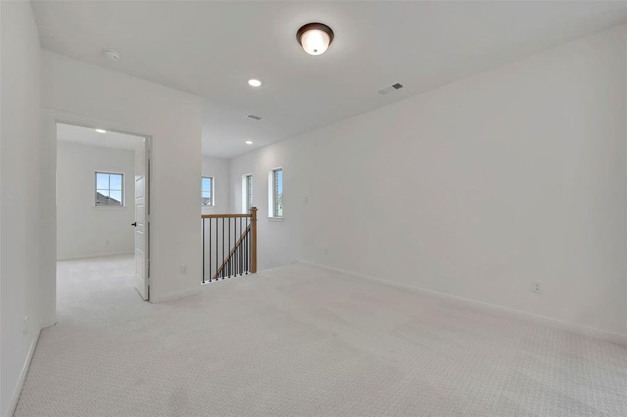 Spare room with light carpet and recessed lighting