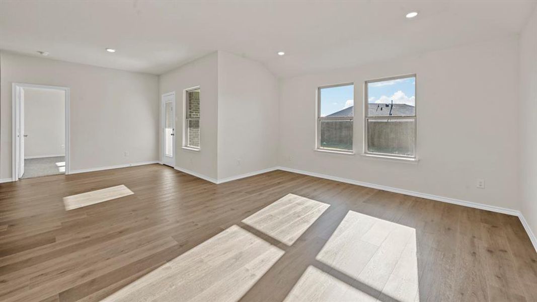 Unfurnished room with light wood-style flooring, recessed lighting, and lofted ceiling