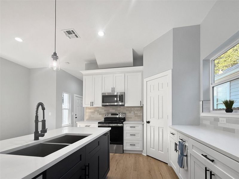 A stunning kitchen designed to impress, featuring a spacious central island perfect for gatherings and meal prep. Outfitted with top-of-the-line materials, from sleek countertops to modern cabinetry, and equipped with high-end appliances. A space that seamlessly blends functionality and style, ideal for the home chef