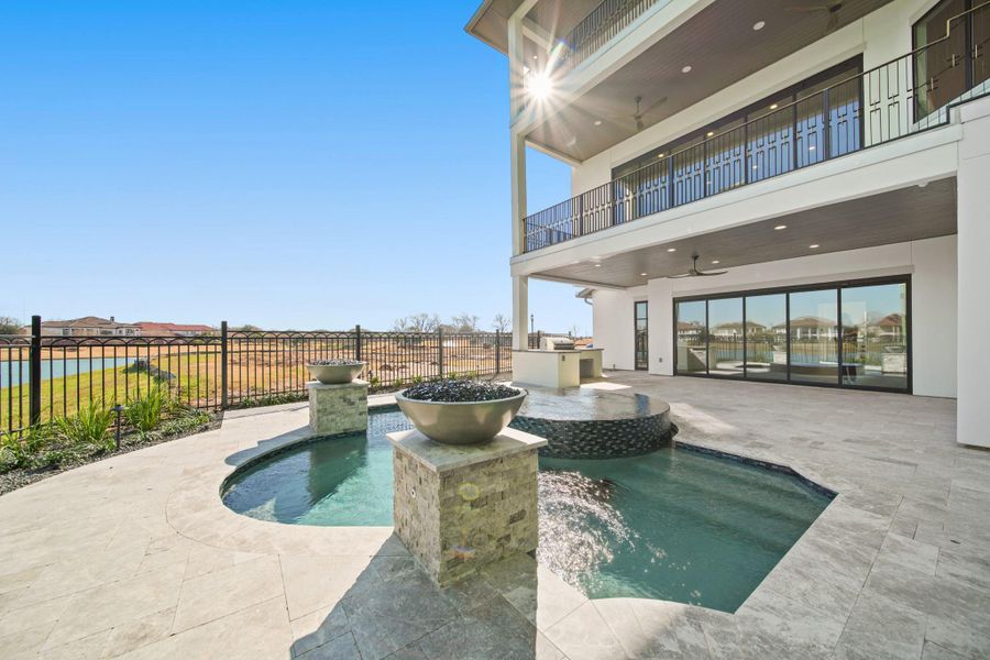 An entertainers dream. Custom pool with a hot tub, and fire and waterfall features. Summer kitchen located on the veranda.