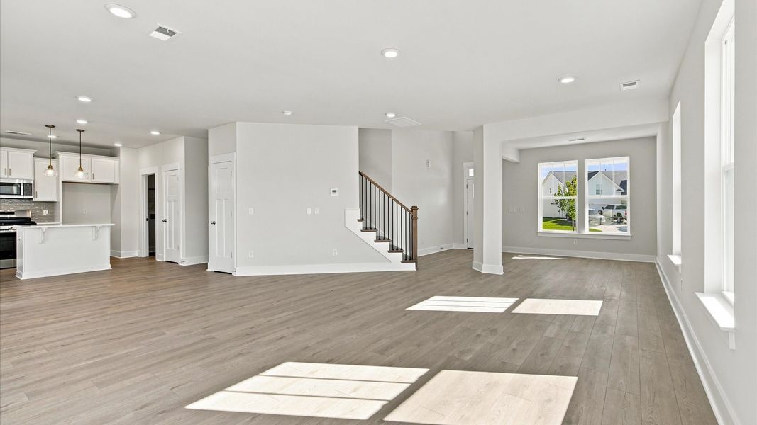 Elegant family room with hardwood flooring and open-concept flow in this first-class DRB Homes design