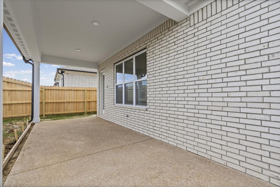Covered patio featuring an exposed aggregate concrete surface Covered patio featuring an exposed aggregate concrete surface