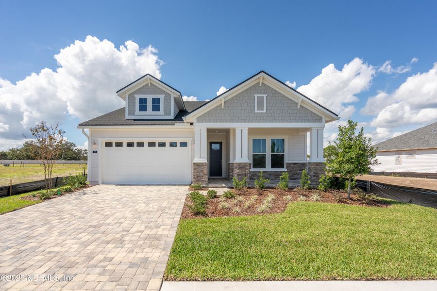 Front exterior of a new home in Madeira, St. Augustine, FL, highlighting curb appeal (Image 1). Front exterior of a new home in Madeira, St. Augustine, FL, highlighting curb appeal (Image 1).