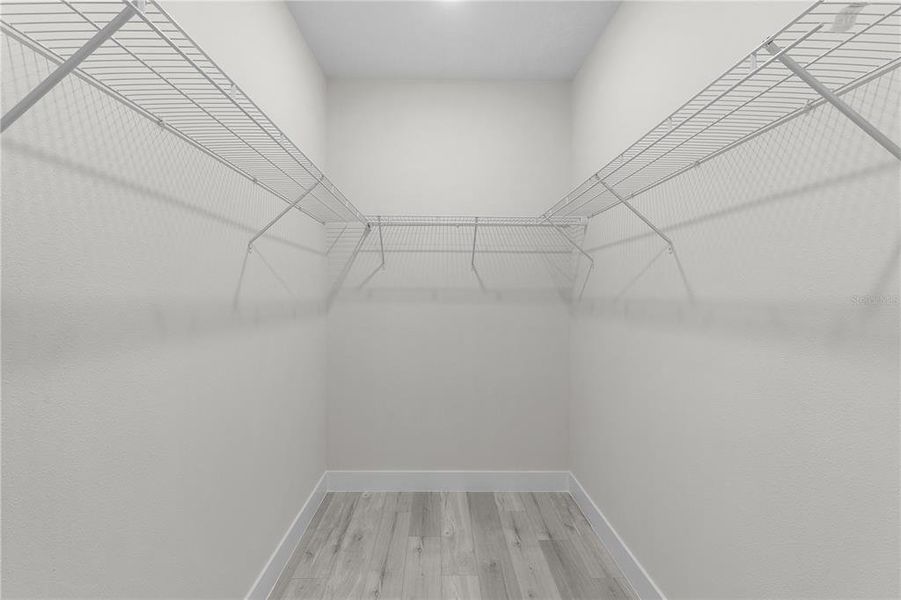 Primary bedroom walk-in closet