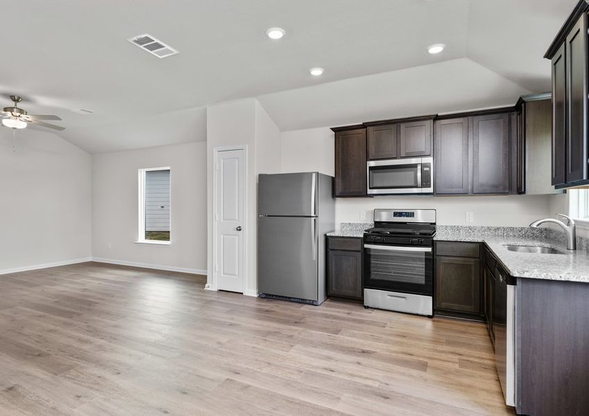 The kitchen has designer wood cabinetry.