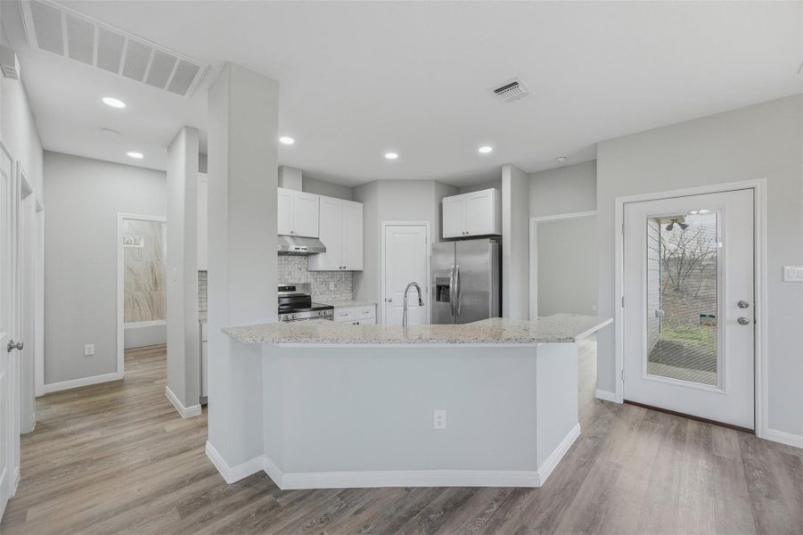 A well-appointed kitchen showcasing contemporary design and convenient breakfast bar seating.