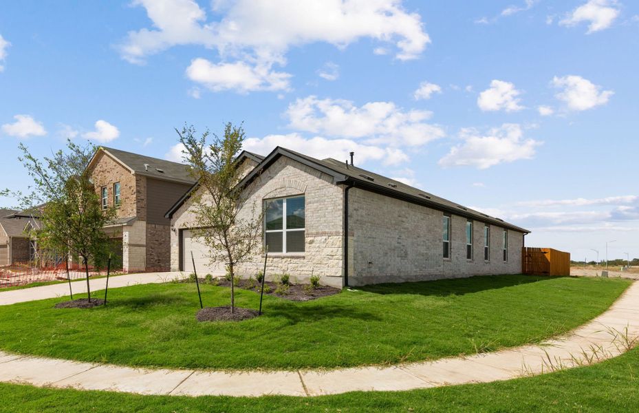 Front exterior of a new home in Lagos, Manor, TX, highlighting curb appeal (Image 18).