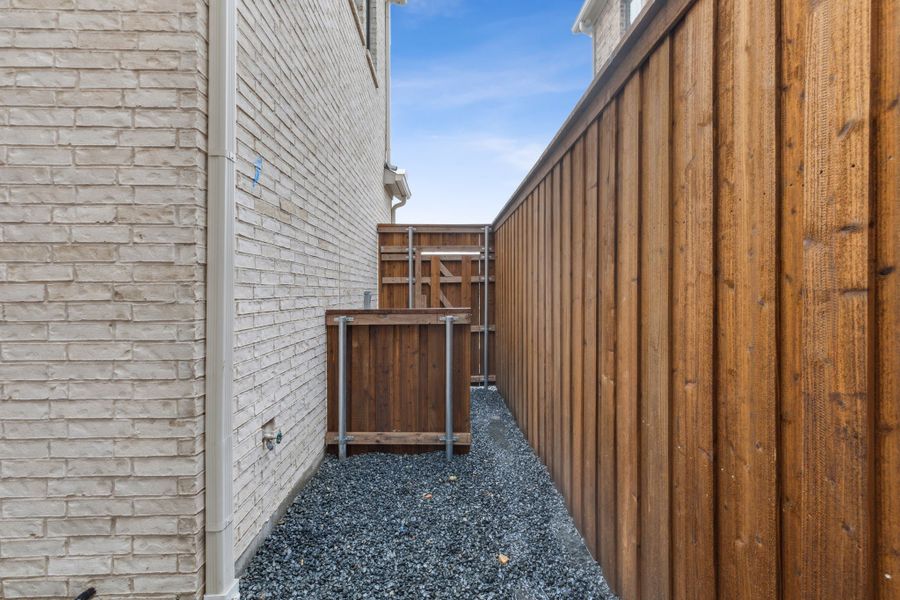 Exterior details and patio area of a home in Newman Village Townhomes, Frisco (Image 3).