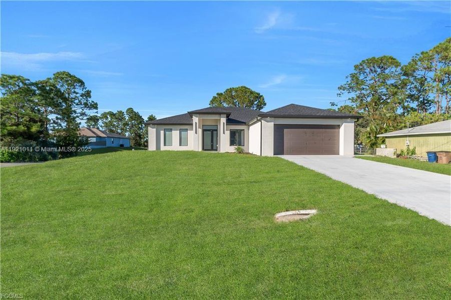 Front exterior of a new home in , Lehigh Acres, FL, highlighting curb appeal (Image 2).