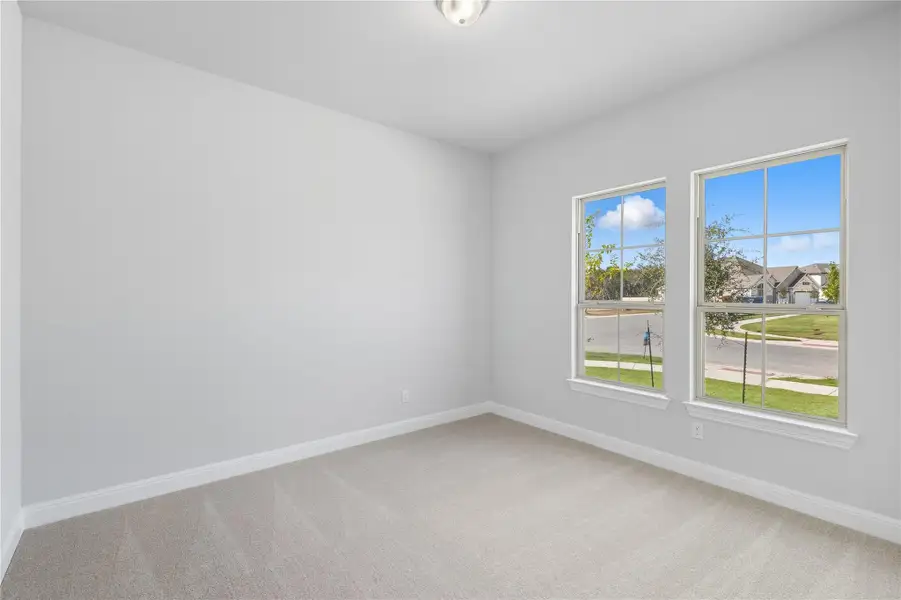 Unfurnished room with baseboards and light carpet Unfurnished room with baseboards and light carpet