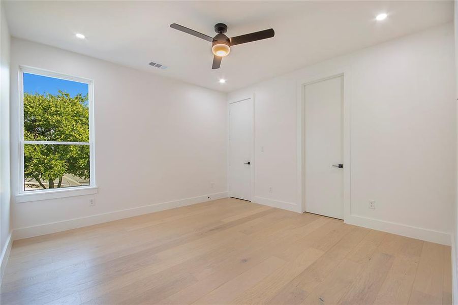 Unfurnished bedroom with light wood finished floors, recessed lighting, and a ceiling fan Unfurnished bedroom with light wood finished floors, recessed lighting, and a ceiling fan