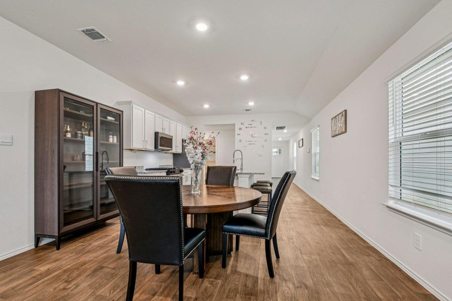 Dining space with light wood-style flooring and recessed lighting
