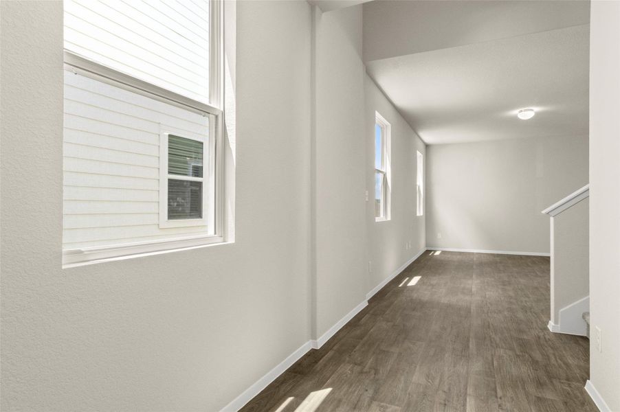 Hall with wood finished floors and stairs