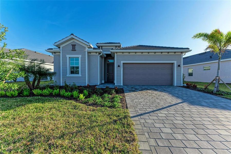Front exterior of a new home in Wellen Park Golf & Country Club: Executive Homes, Venice, FL, highlighting curb appeal (Image 22).