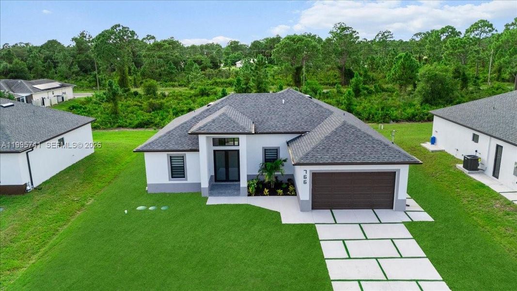 Front exterior of a new home in , Lehigh Acres, FL, highlighting curb appeal (Image 25). Front exterior of a new home in , Lehigh Acres, FL, highlighting curb appeal (Image 25).