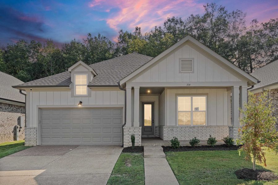 View of front of home featuring brick siding, driveway, roof with shingles, and board and batten siding