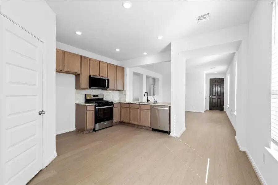Create lasting memories with family and friends in this inviting kitchen/dining room! It showcases high ceilings, recessed lighting, custom paint, large window with blinds, and an access door to the backyard. Create lasting memories with family and friends in this inviting kitchen/dining room! It showcases high ceilings, recessed lighting, custom paint, large window with blinds, and an access door to the backyard.