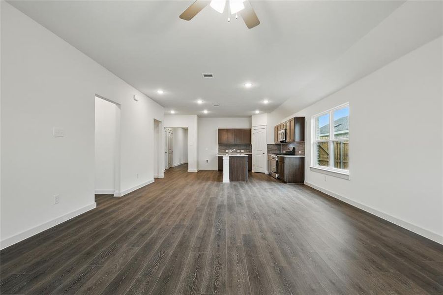 Unfurnished living room featuring a ceiling fan, dark wood-style flooring, and recessed lighting Unfurnished living room featuring a ceiling fan, dark wood-style flooring, and recessed lighting