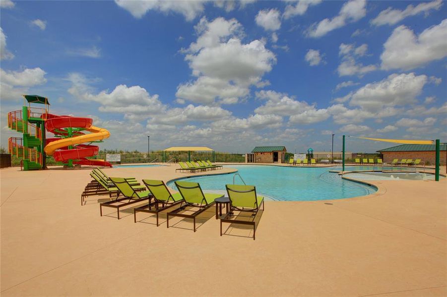 View of swimming pool with a patio, a water slide, and a playground