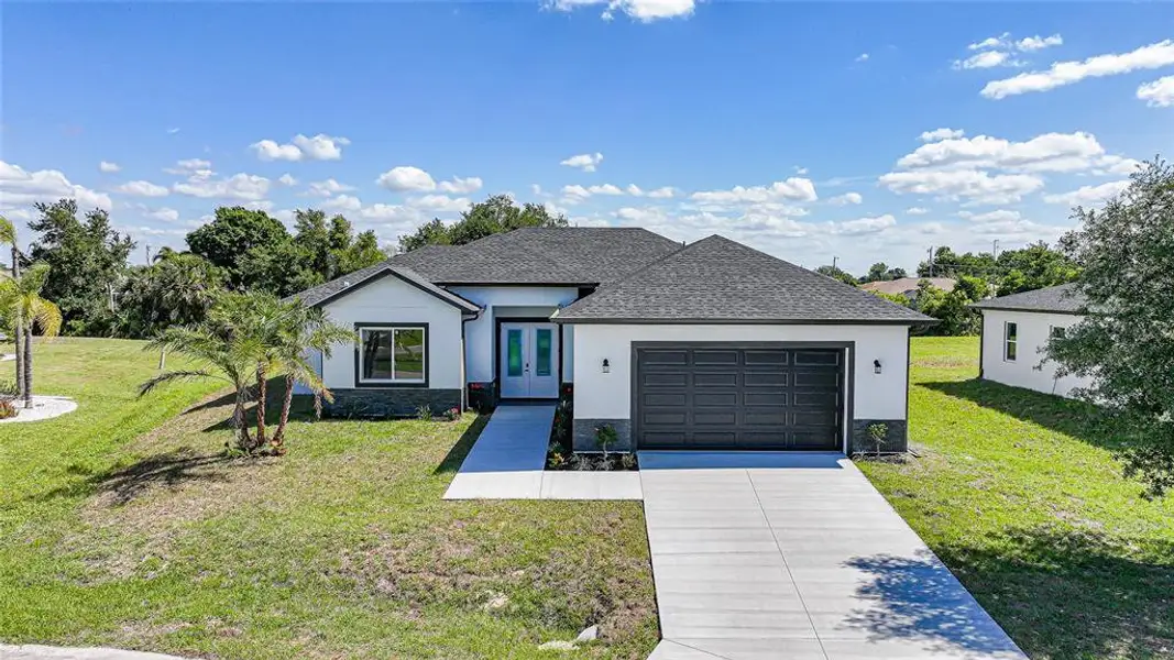 Front exterior of a new home in , Punta Gorda, FL, highlighting curb appeal (Image 23).