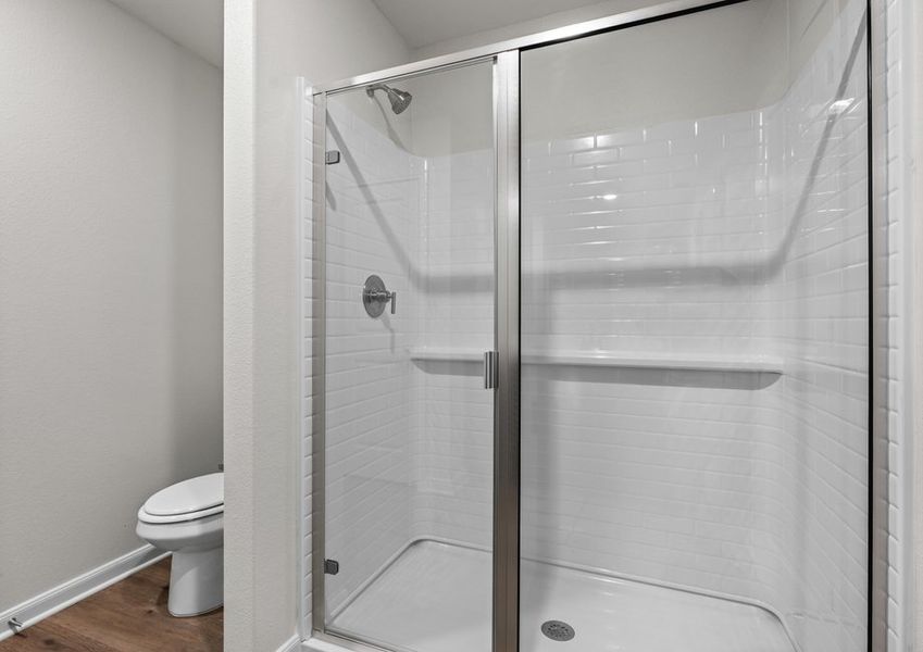 The master bathroom has a walk-in, glass shower.