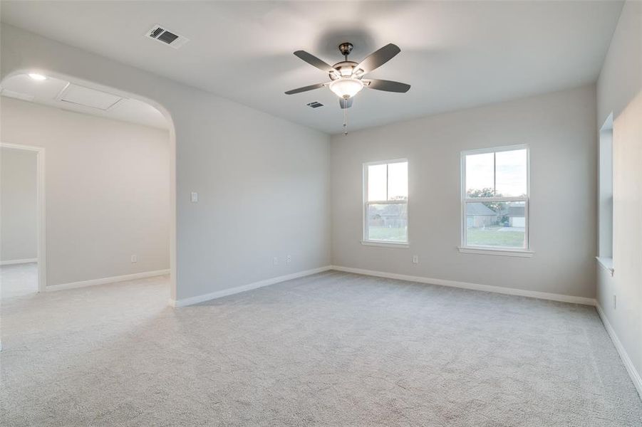 Unfurnished room featuring ceiling fan and light colored carpet