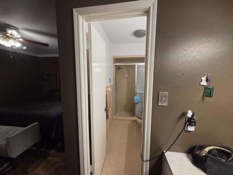 Full bath with connected bathroom, a ceiling fan, and a shower stall Full bath with connected bathroom, a ceiling fan, and a shower stall