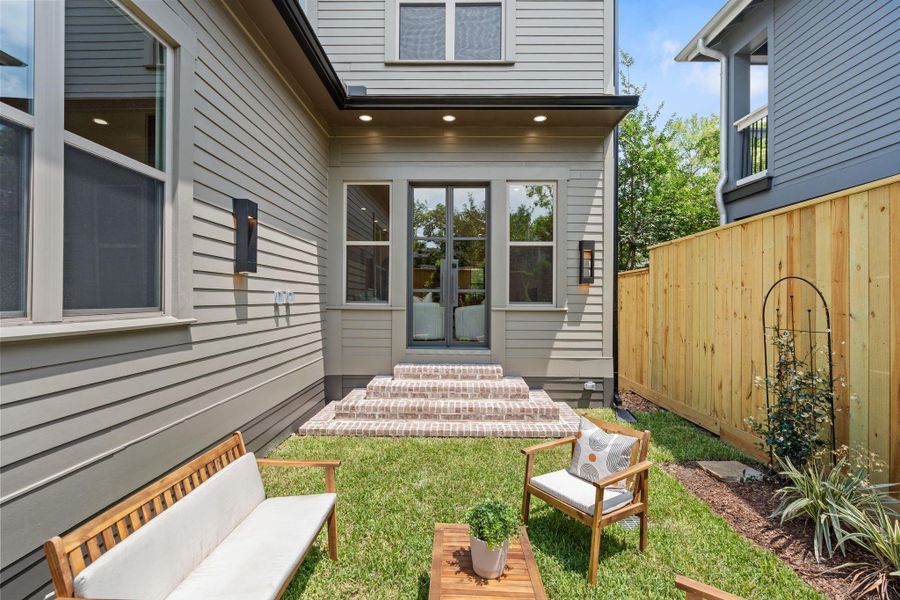 Brick steps leading to a low-maintenance garden, complete with outdoor outlets and gas connections for future entertaining