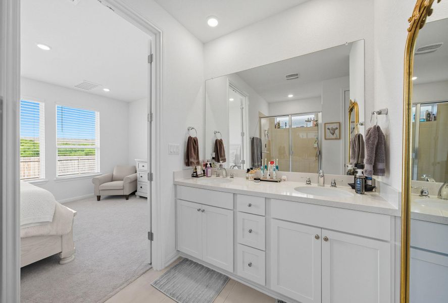 Ensuite bathroom with plenty of natural light, a stall shower, double vanity, and recessed lighting Ensuite bathroom with plenty of natural light, a stall shower, double vanity, and recessed lighting