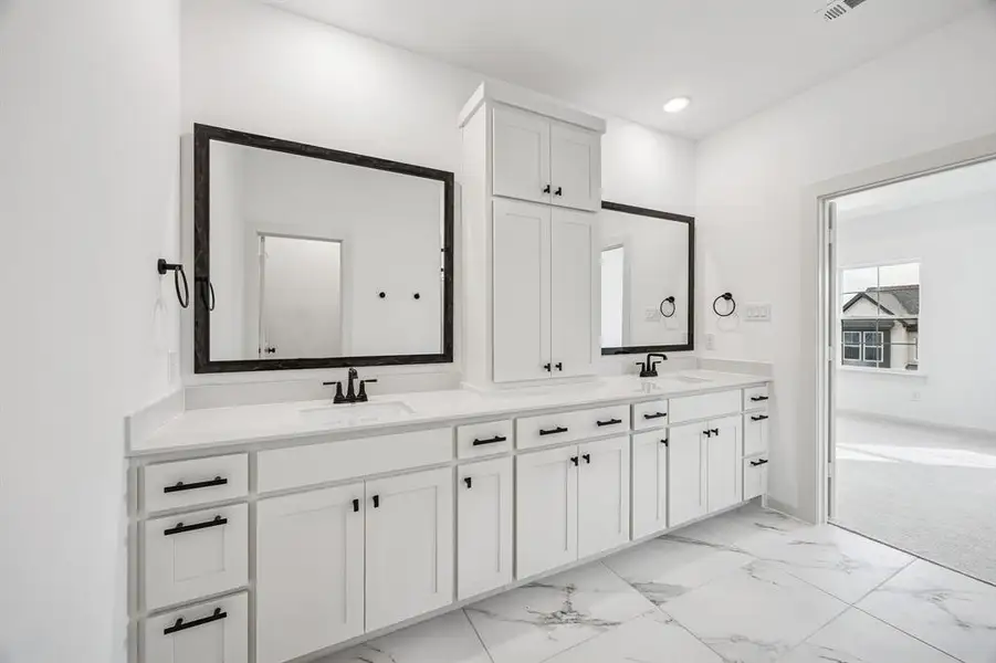 No shortage of space or style in this crisp, clean, contemporary owner's bath!