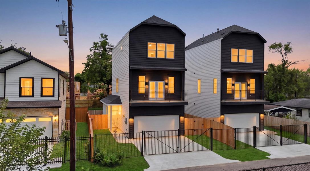 This is the one you've been waiting for — a stunning modern new construction glowing against a twilight sky, with warm interior lighting, sleek black iron gating, and manicured lawn that makes coming home feel like arriving somewhere special every single time. This is the one you've been waiting for — a stunning modern new construction glowing against a twilight sky, with warm interior lighting, sleek black iron gating, and manicured lawn that makes coming home feel like arriving somewhere special every single time.
