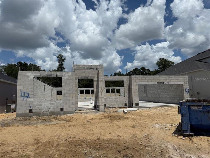 Front exterior of a new home in Emerson Pointe, Apopka, FL, highlighting curb appeal (Image 2). Front exterior of a new home in Emerson Pointe, Apopka, FL, highlighting curb appeal (Image 2).