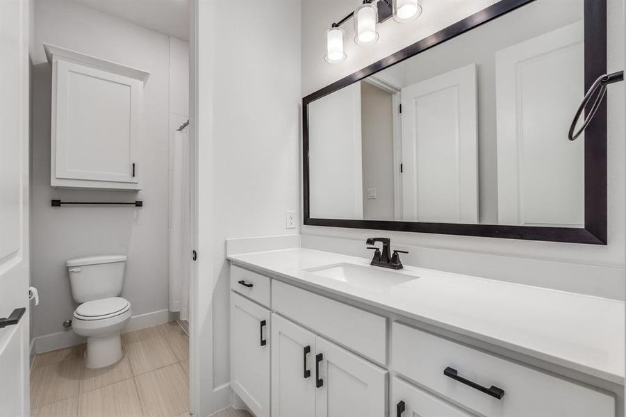 Bathroom featuring vanity and toilet