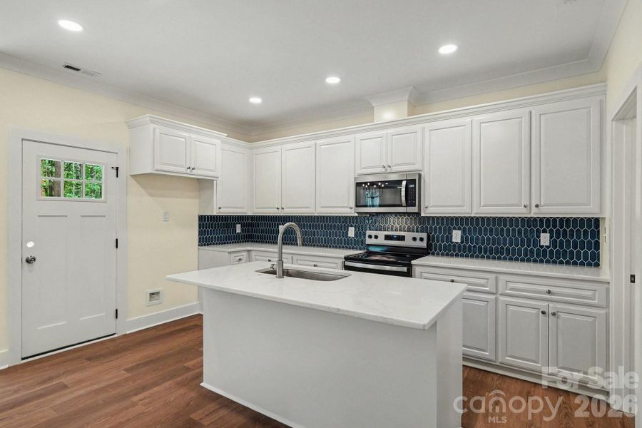 Sparkling kitchen with sharp blue tiled backsplash Sparkling kitchen with sharp blue tiled backsplash
