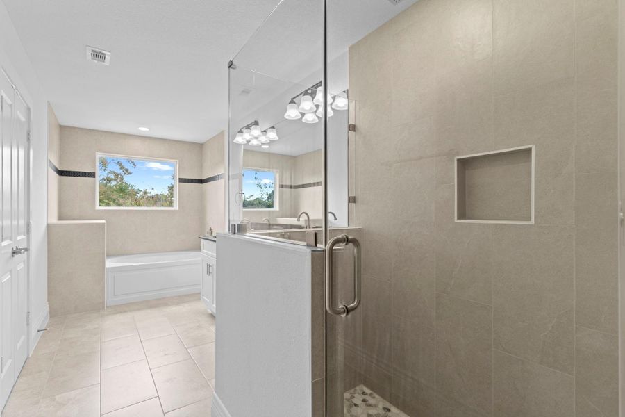 Escape to your spa-inspired bathroom retreat! Enjoy the gorgeous large tile floors and the beautifully designed layout that perfectly complements the primary suite. What a stunning space to relax and unwind! Escape to your spa-inspired bathroom retreat! Enjoy the gorgeous large tile floors and the beautifully designed layout that perfectly complements the primary suite. What a stunning space to relax and unwind!