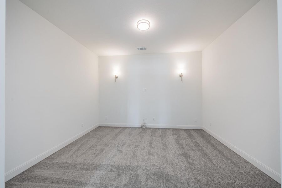 Spare room with light colored carpet and baseboards