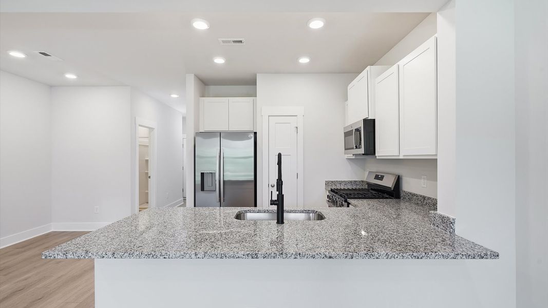 Beautifully appointed kitchen with spacious counters and sophisticated detailing by DRB Homes Beautifully appointed kitchen with spacious counters and sophisticated detailing by DRB Homes