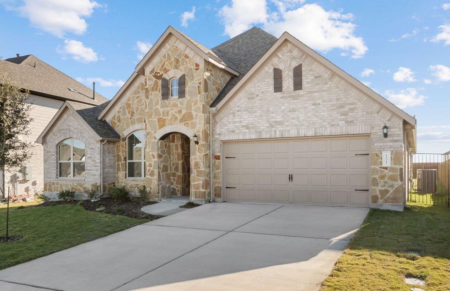 Front exterior of a new home in Saddleback at Santa Rita Ranch, Liberty Hill, TX, highlighting curb appeal (Image 23).