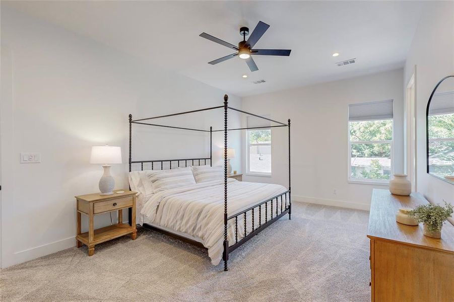 Carpeted bedroom featuring ceiling fan