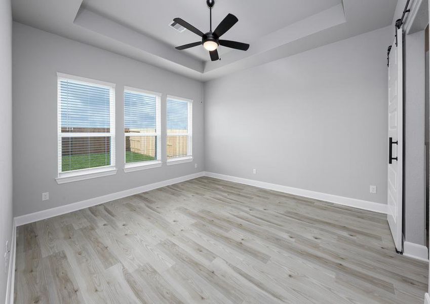 Master bedroom with large windows.