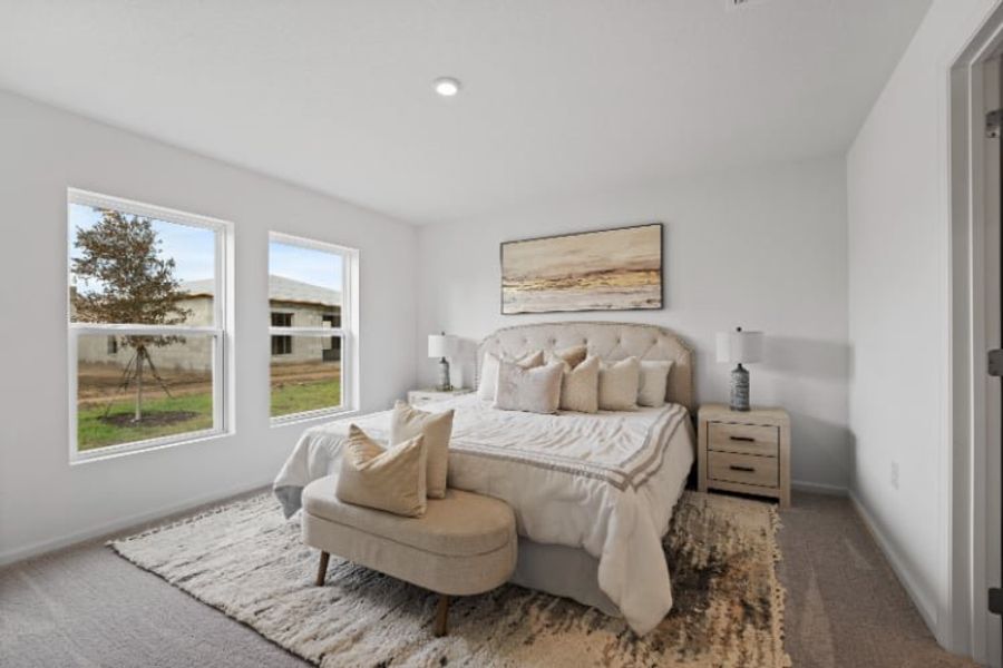 A bedroom with a bed and a couch.