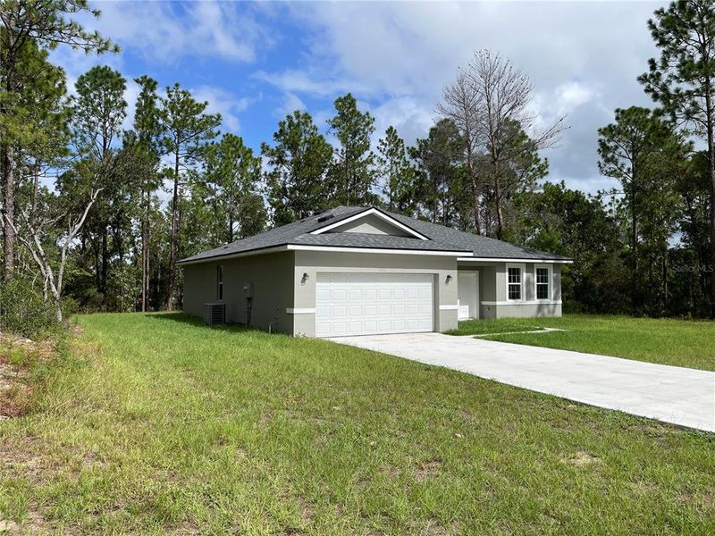 Front exterior of a new home in , Ocala, FL, highlighting curb appeal (Image 1). Front exterior of a new home in , Ocala, FL, highlighting curb appeal (Image 1).