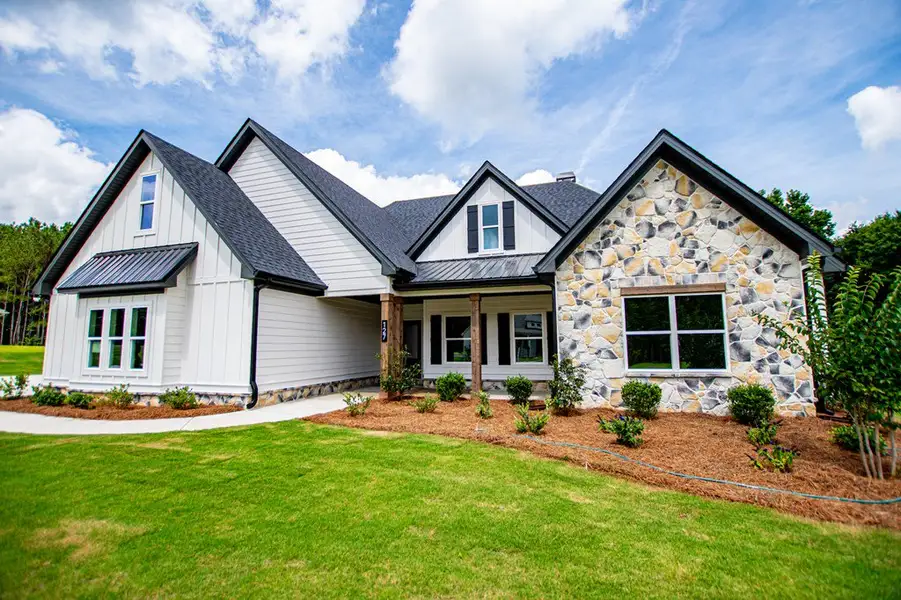 Front exterior of a new home in WOODMONT RESERVE, Roopville, GA, highlighting curb appeal (Image 35).