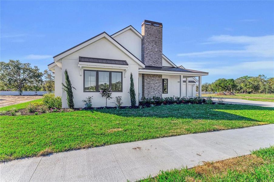 Front exterior of a new home in , Sarasota, FL, highlighting curb appeal (Image 1). Front exterior of a new home in , Sarasota, FL, highlighting curb appeal (Image 1).